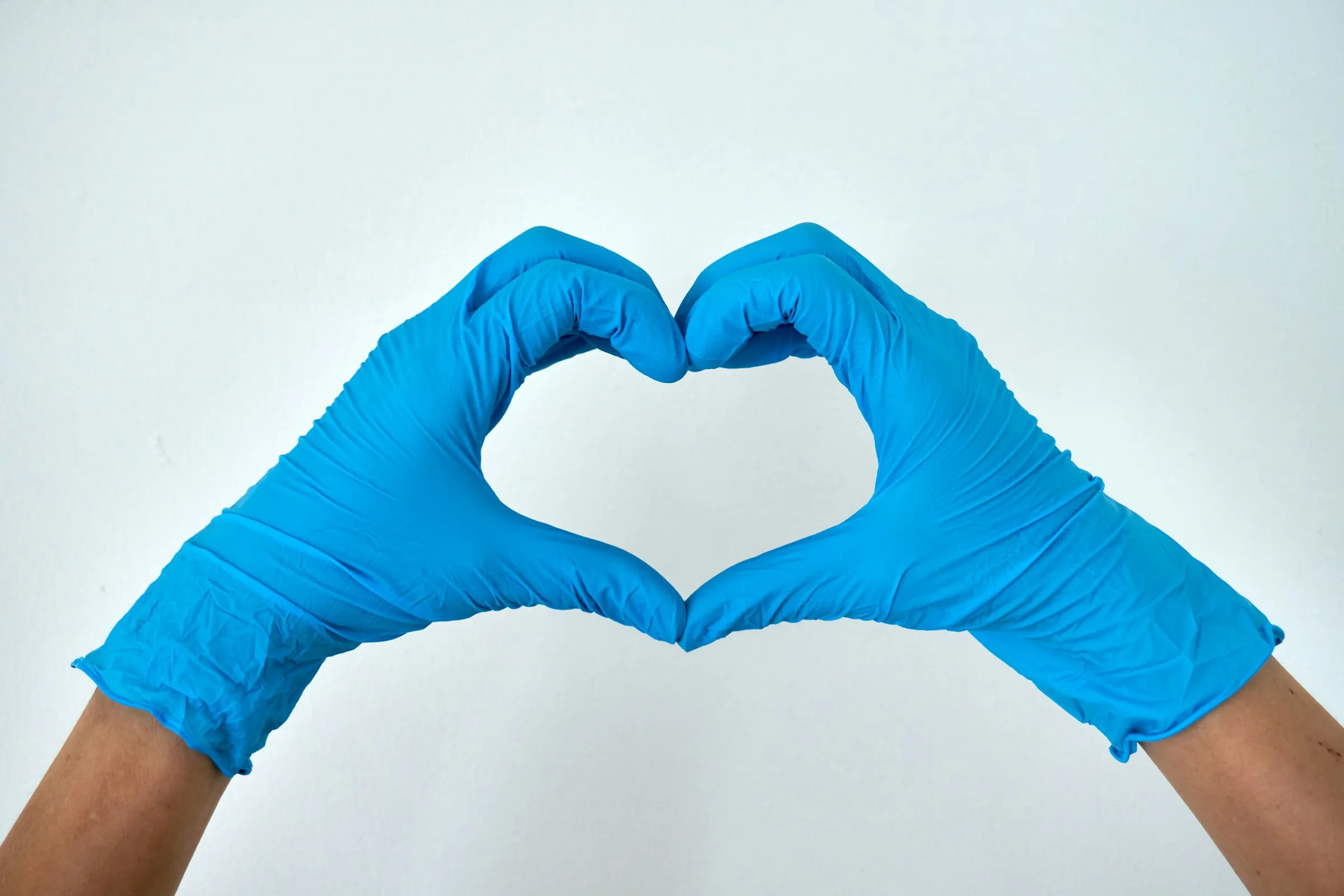 gloved hands forming heart