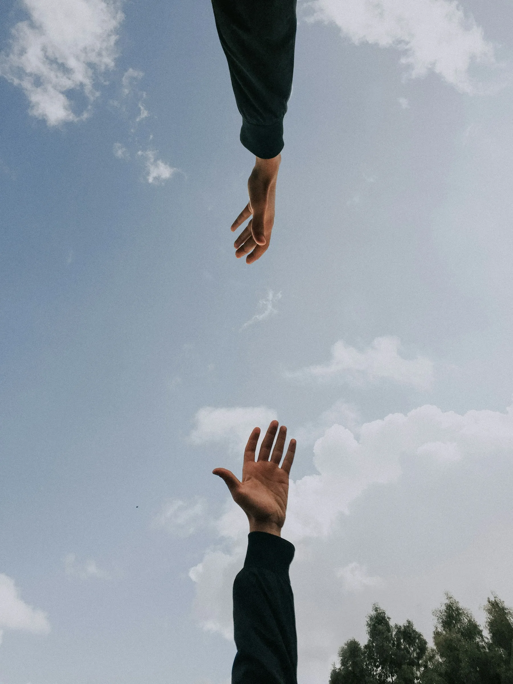 two hands reaching for each other
