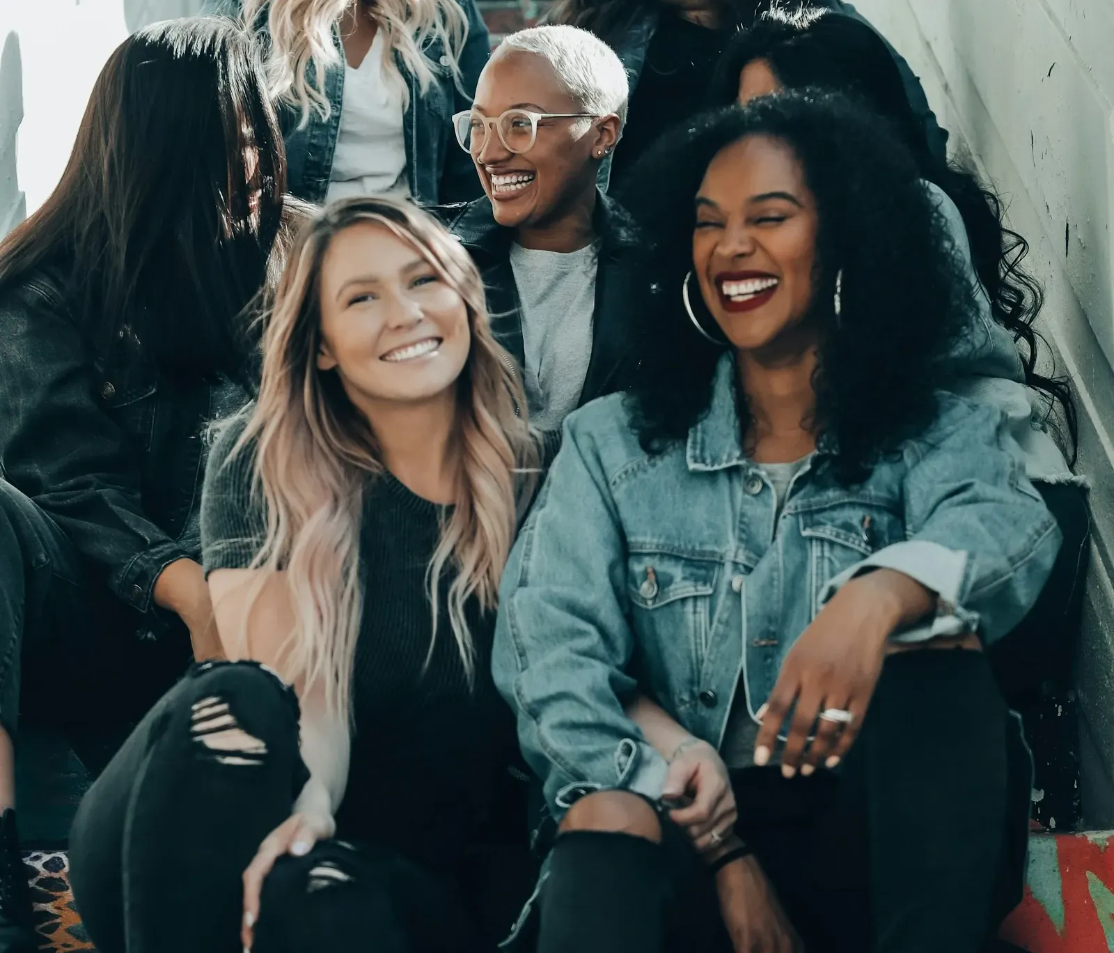 group of women laughing on stairs