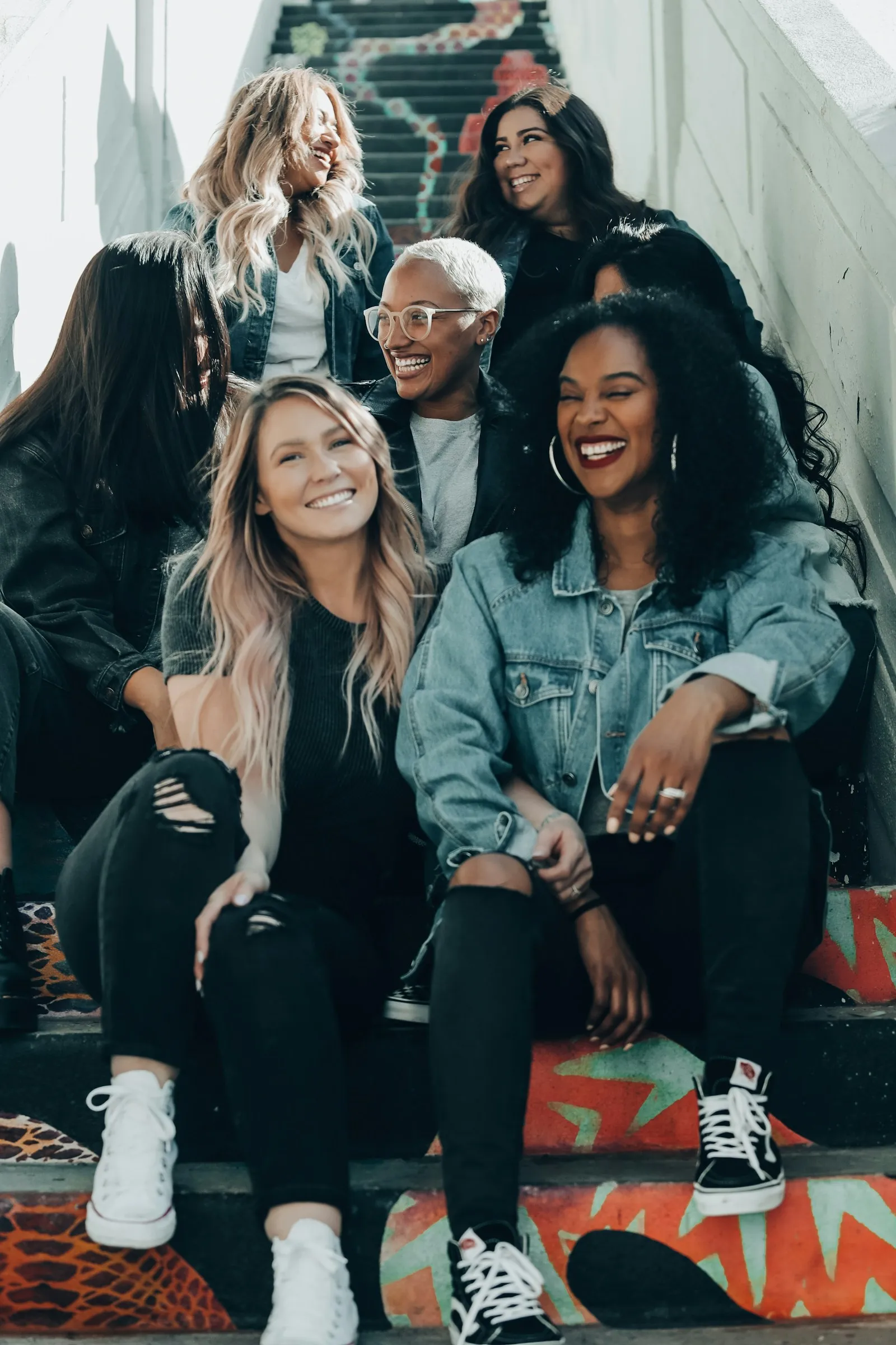 Photo by Joel Muniz group of women laughing on stairs