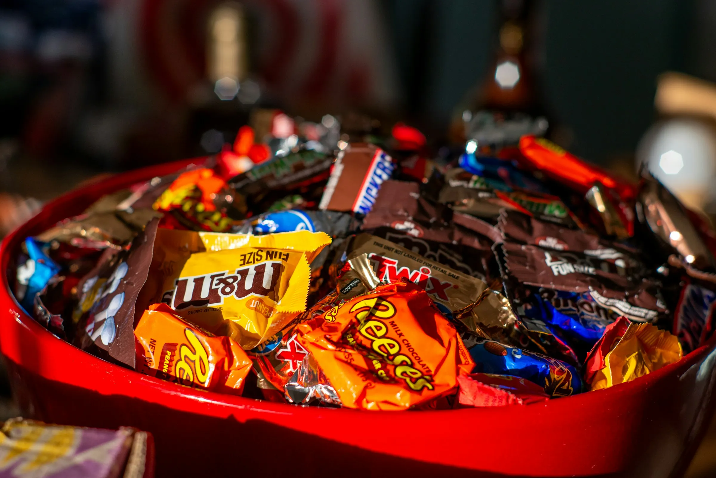 a red bowl filled with lots of candy